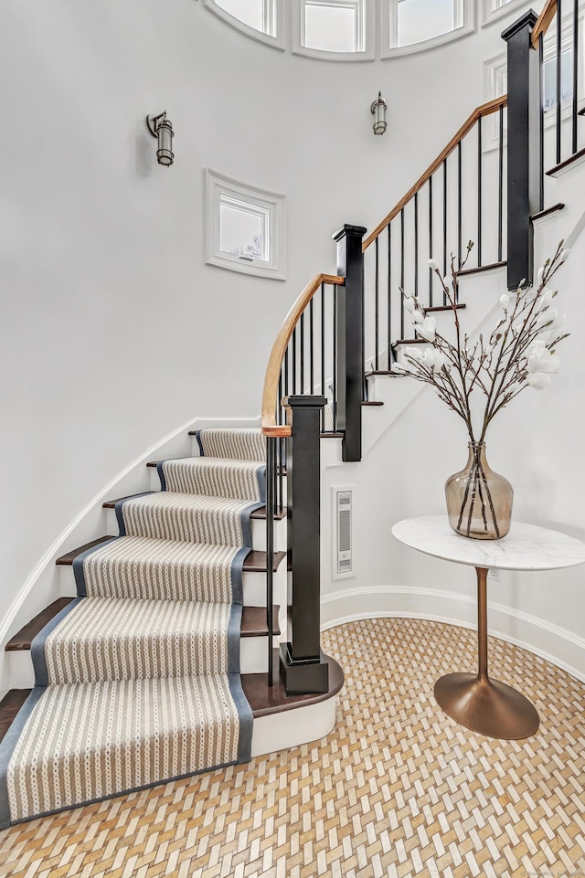 staircase with a high ceiling
