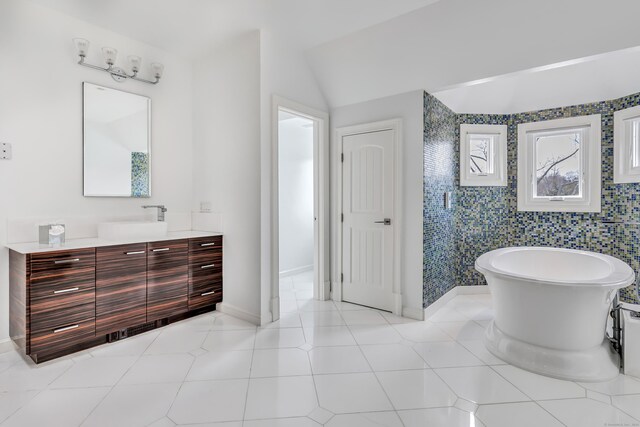 29 Covelee Dr, Norwalk, CT 06855 - full bathroom with vanity, a freestanding bath, baseboards, and vaulted ceiling