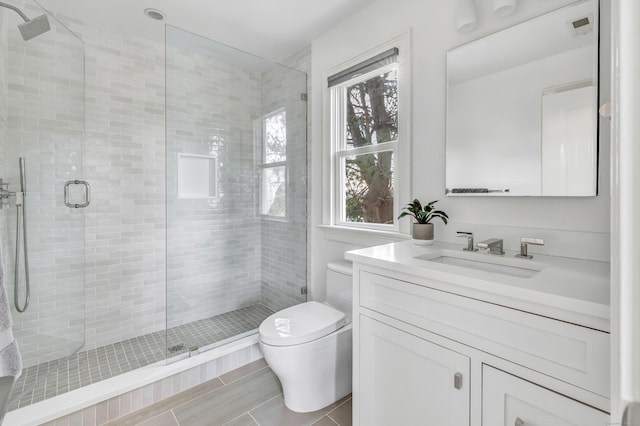 full bath with toilet, visible vents, a shower stall, and vanity