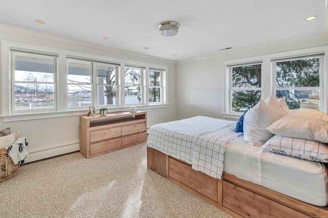 carpeted bedroom with visible vents, a baseboard radiator, crown molding, and multiple windows
