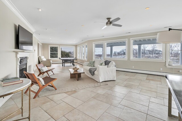 29 Covelee Dr, Norwalk, CT 06855 - living area with healthy amount of natural light, baseboard heating, a glass covered fireplace, crown molding, and ceiling fan