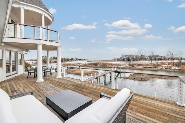 dock area featuring a water view and a balcony