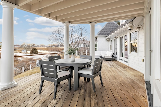 deck with outdoor lounge area, french doors, and outdoor dining space