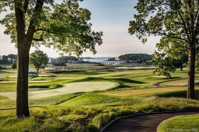 surrounding community featuring view of golf course and a water view