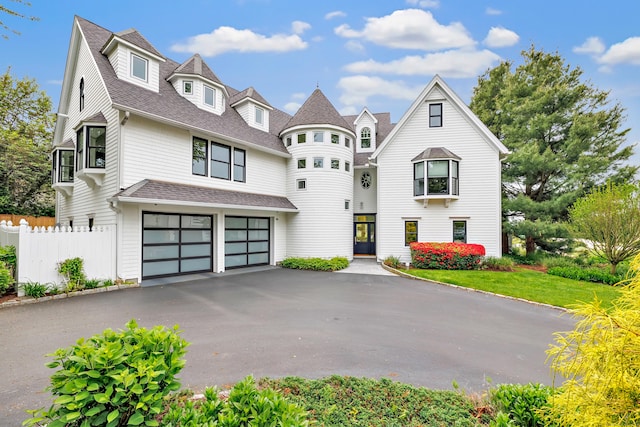 29 Covelee Dr, Norwalk, CT 06855 - view of front facade with driveway, an attached garage, and a shingled roof
