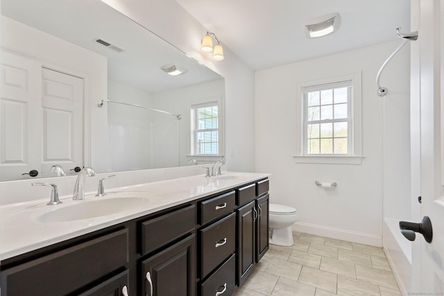 full bath with double vanity, baseboards, visible vents, and a sink