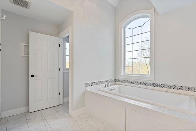 full bath featuring baseboards, marble finish floor, a bath, and visible vents