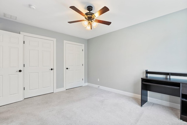 unfurnished bedroom with a ceiling fan, baseboards, light colored carpet, and visible vents