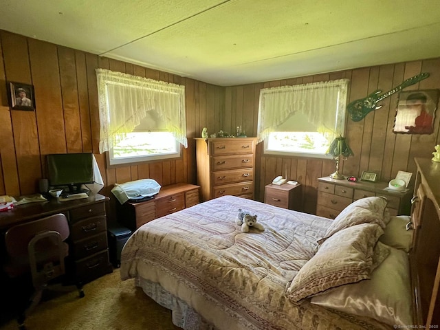 bedroom with wood walls and carpet
