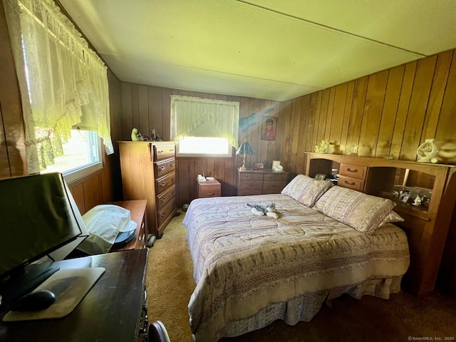 carpeted bedroom with wood walls