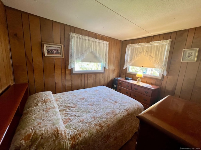 bedroom featuring wooden walls