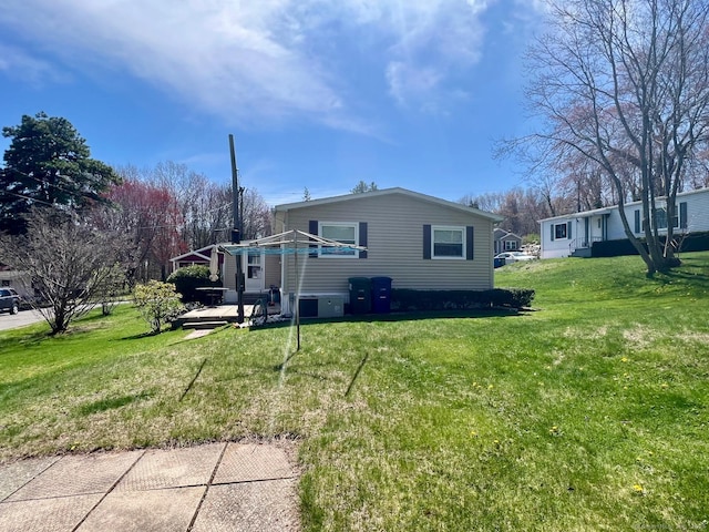 view of side of property with a lawn
