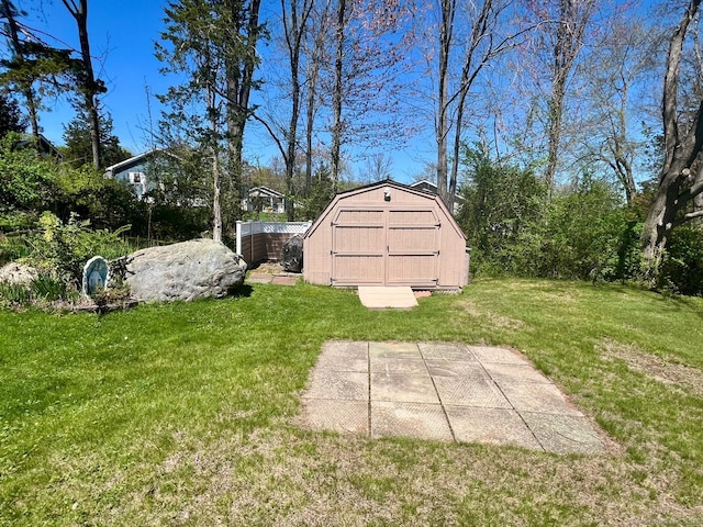 view of yard featuring a storage shed and an outbuilding