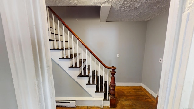 129 Walnut St, Windham, CT 06226 - staircase with a textured ceiling, baseboards, baseboard heating, and wood finished floors