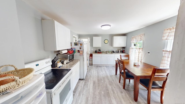 129 Walnut St, Windham, CT 06226 - kitchen featuring white cabinets, light countertops, light wood-style floors, and white appliances