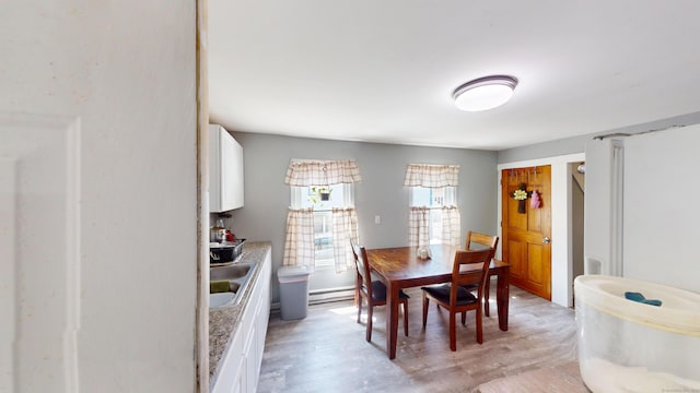 129 Walnut St, Windham, CT 06226 - dining space with light wood-style flooring and baseboard heating