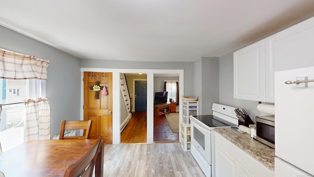 129 Walnut St, Windham, CT 06226 - kitchen featuring white cabinets, light wood-type flooring, light stone counters, and white appliances