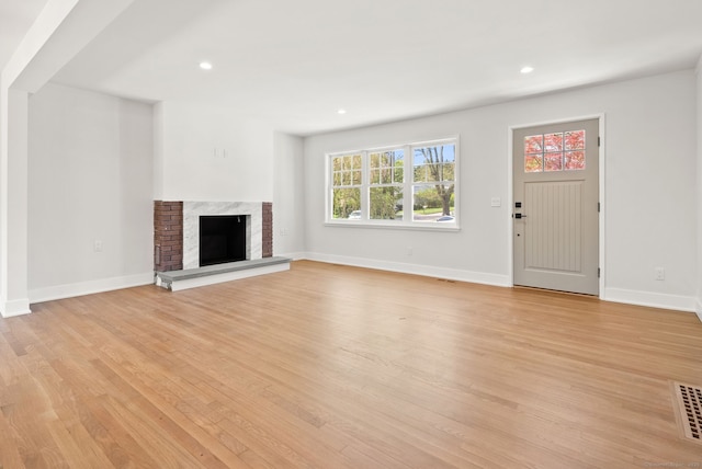 183 Pepperidge Cir, Fairfield, CT 06824 - unfurnished living room with light wood-style flooring, recessed lighting, a high end fireplace, and baseboards