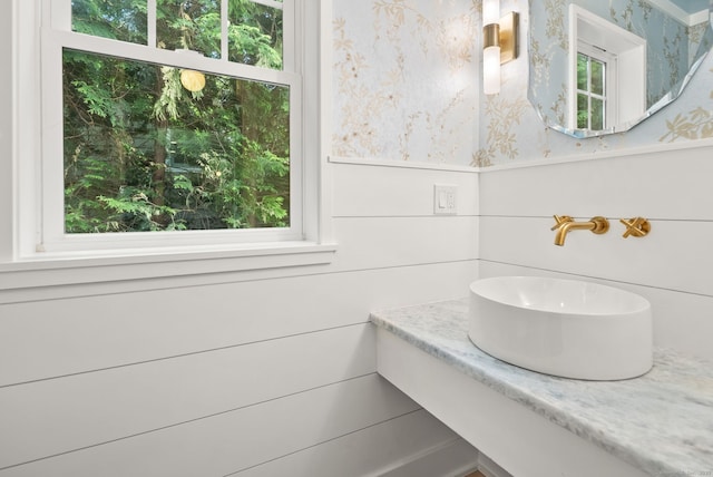 183 Pepperidge Cir, Fairfield, CT 06824 - bathroom with healthy amount of natural light, a sink, and wallpapered walls