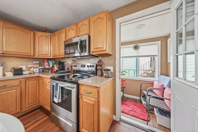 839 Washington Avenue Extension, Waterbury, CT 06708 - kitchen with stainless steel appliances, dark wood finished floors, light countertops, and backsplash