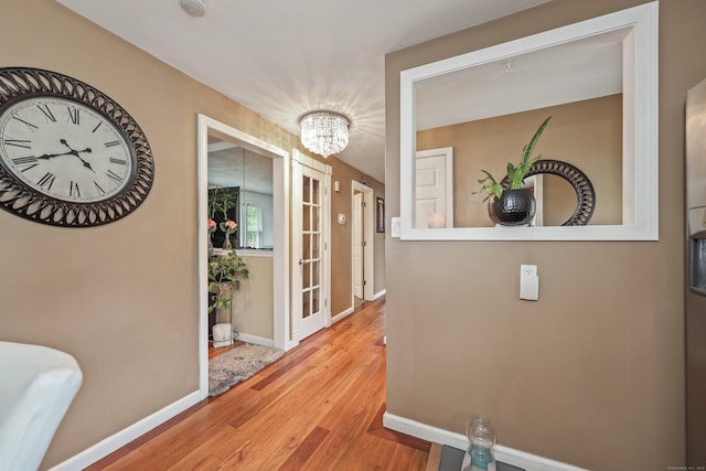 839 Washington Avenue Extension, Waterbury, CT 06708 - corridor featuring wood finished floors, a chandelier, and baseboards