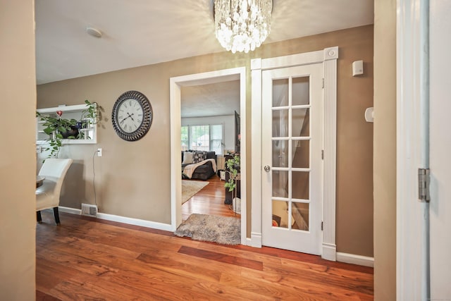 839 Washington Avenue Extension, Waterbury, CT 06708 - entryway with wood finished floors, baseboards, and a chandelier