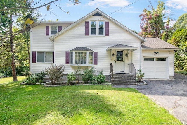 view of front facade featuring a garage, driveway, and a front yard