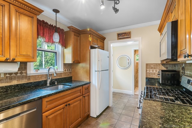 kitchen featuring brown cabinetry, a sink, ornamental molding, and stainless steel appliances