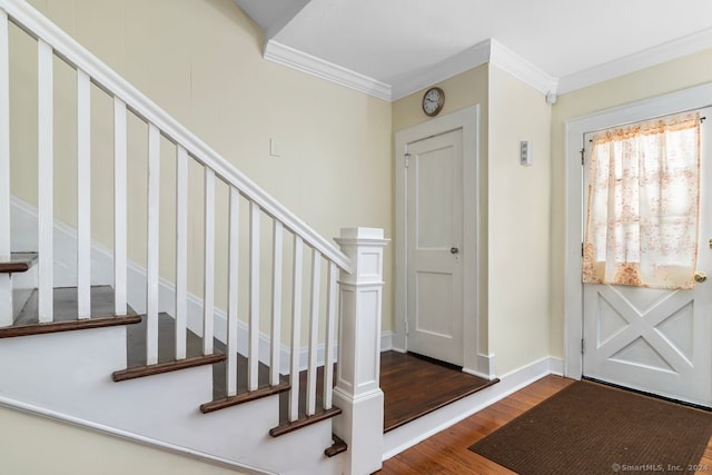foyer with stairway, ornamental molding, and wood finished floors