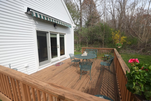 deck featuring outdoor dining space and french doors