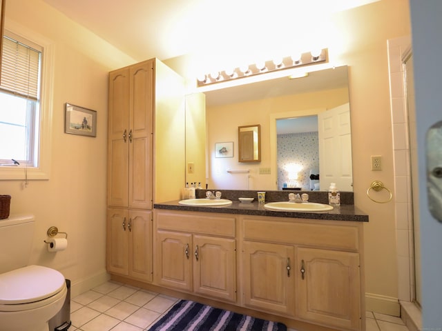 full bathroom featuring tile patterned flooring, toilet, double vanity, baseboards, and a shower with shower door
