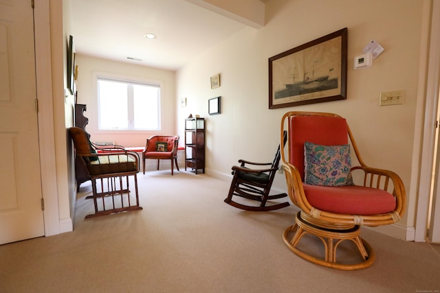 living area featuring carpet and baseboards