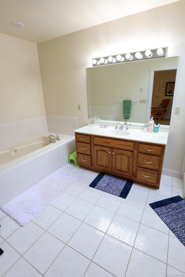 bathroom with vanity, tile patterned flooring, a garden tub, and ensuite bath