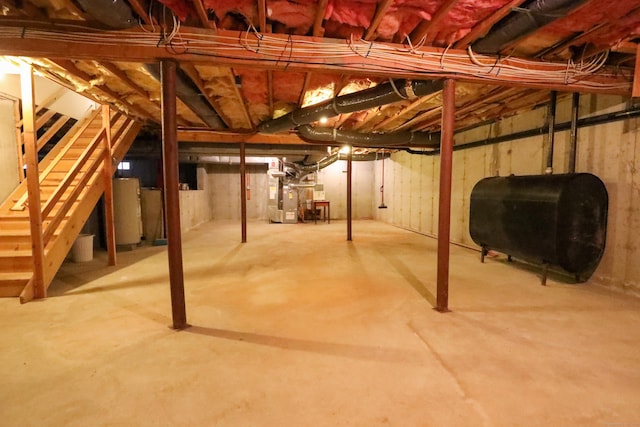 unfinished basement with heating fuel, water heater, and heating unit