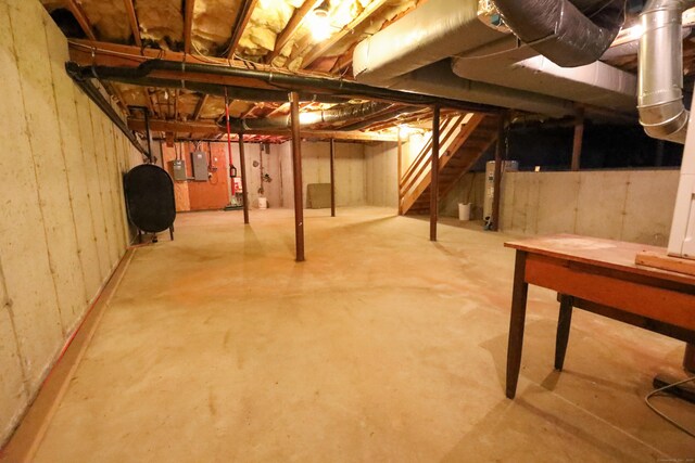 unfinished basement featuring heating fuel and electric panel