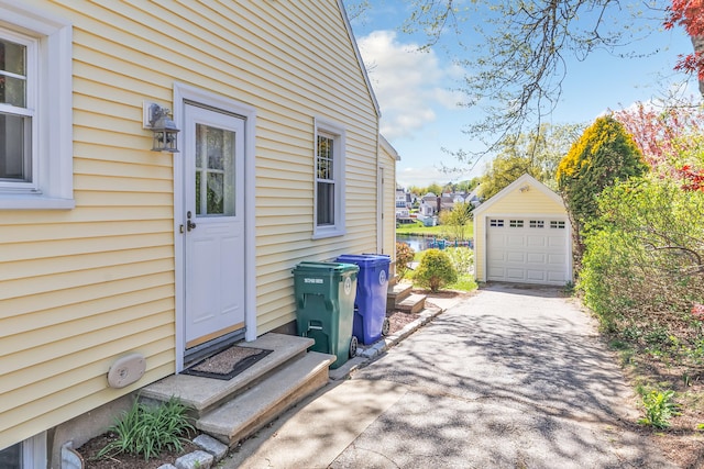 exterior space featuring a garage, a water view, and concrete driveway