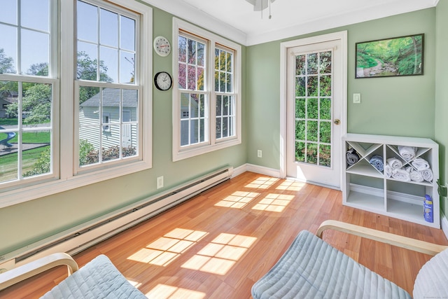 doorway to outside with baseboards, baseboard heating, and light wood-style floors