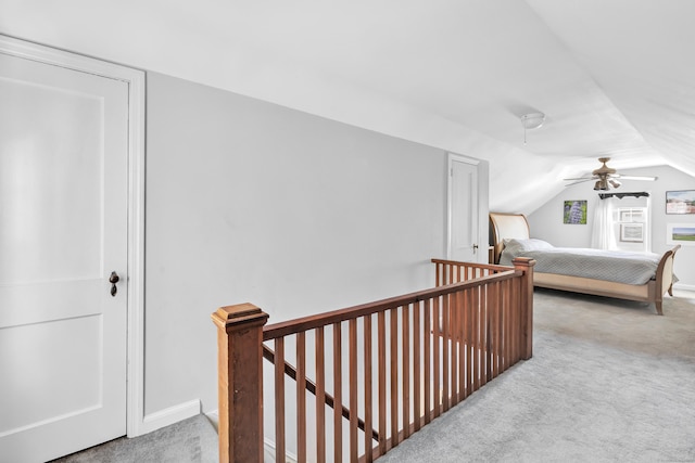 carpeted bedroom with baseboards and vaulted ceiling