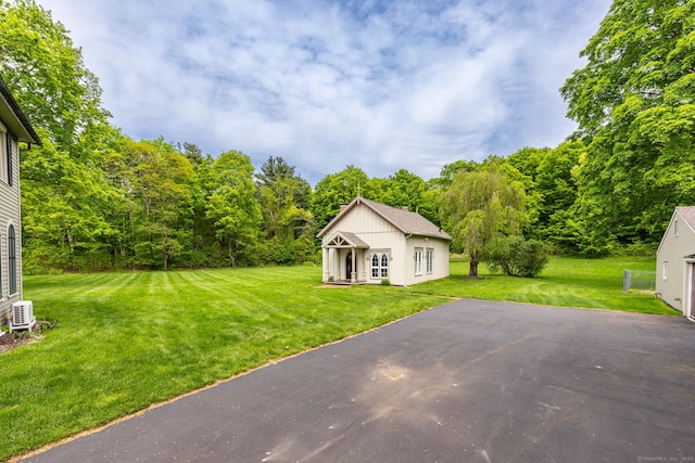 290 Waterville Rd, Avon, CT 06001 - view of grassy yard featuring driveway, a view of trees, and an outbuilding