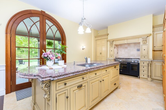 290 Waterville Rd, Avon, CT 06001 - kitchen with cream cabinets, range with two ovens, and a sink