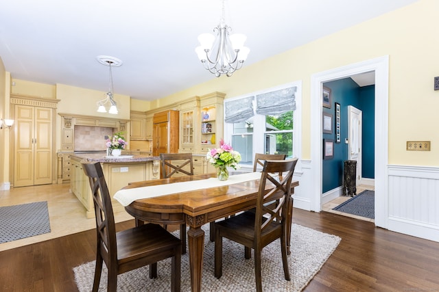 290 Waterville Rd, Avon, CT 06001 - dining space with a chandelier, a wainscoted wall, light wood finished floors, and a decorative wall