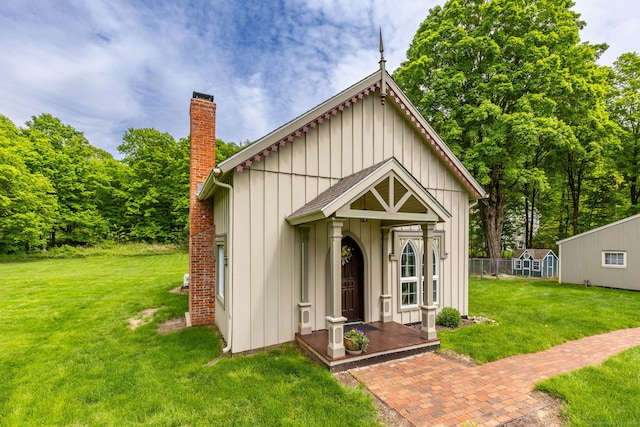 290 Waterville Rd, Avon, CT 06001 - view of front of home featuring a chimney, a front yard, board and batten siding, and an outbuilding