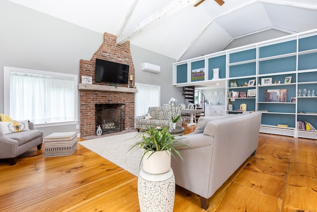 290 Waterville Rd, Avon, CT 06001 - living area with vaulted ceiling, a fireplace, ceiling fan, hardwood / wood-style flooring, and a wall mounted air conditioner