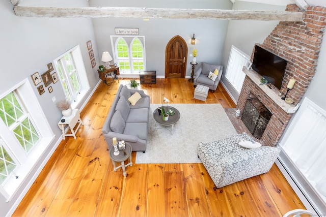 290 Waterville Rd, Avon, CT 06001 - living room with a brick fireplace, hardwood / wood-style floors, a baseboard radiator, and high vaulted ceiling