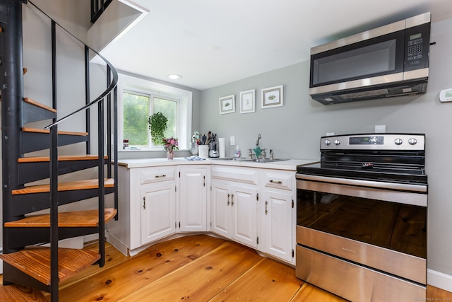 290 Waterville Rd, Avon, CT 06001 - kitchen with appliances with stainless steel finishes, a sink, white cabinetry, light countertops, and recessed lighting