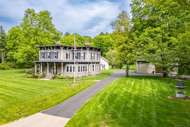 290 Waterville Rd, Avon, CT 06001 - back of property featuring covered porch, a chimney, a lawn, and an outbuilding