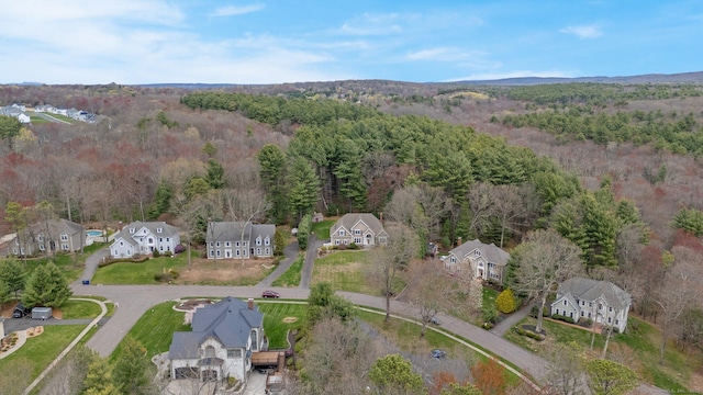 aerial view featuring a residential view and a wooded view