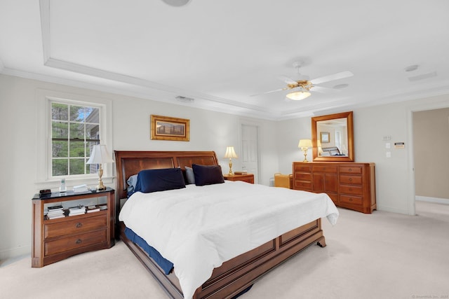 bedroom with light colored carpet, a raised ceiling, a ceiling fan, visible vents, and ornamental molding