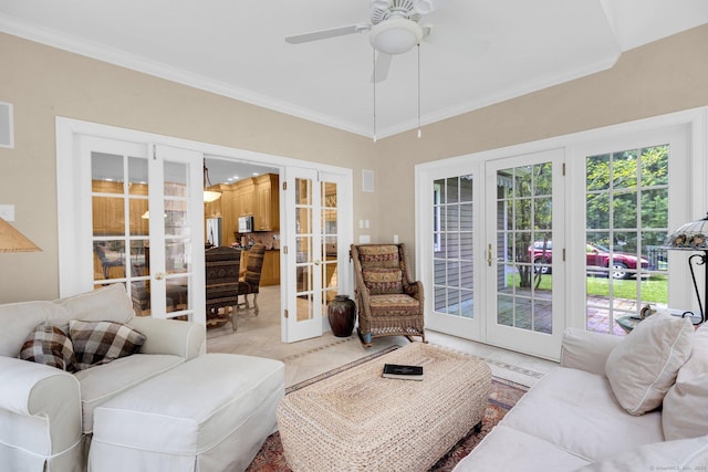 living room featuring french doors, a ceiling fan, and crown molding