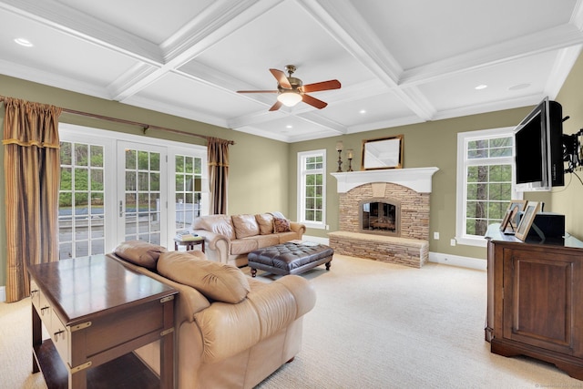 living area featuring beam ceiling, light colored carpet, plenty of natural light, a ceiling fan, and coffered ceiling